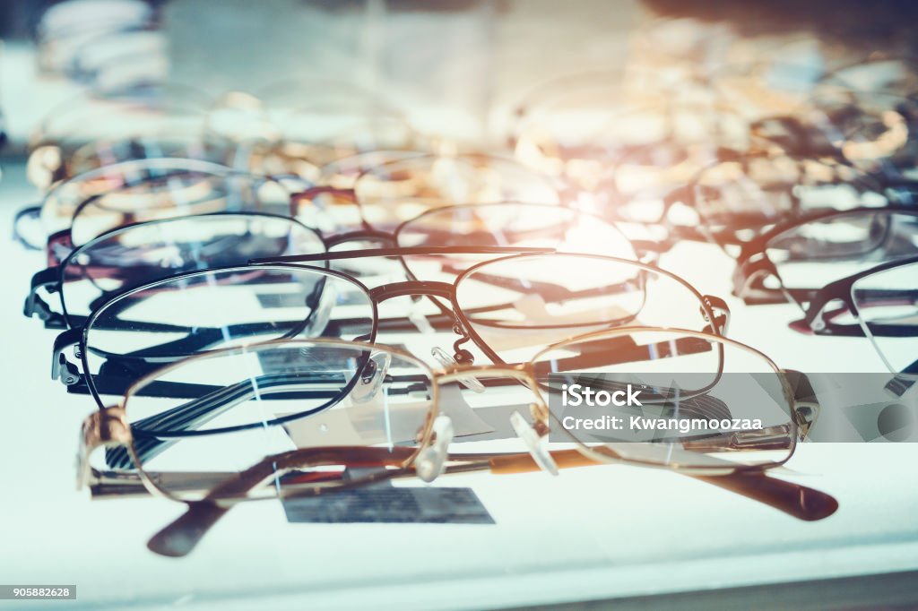 Eye glasses on window display shelves in optics store Eyeglasses Stock Photo