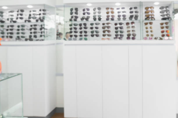 Blur Sunglasses on display shelves in glasses store background
