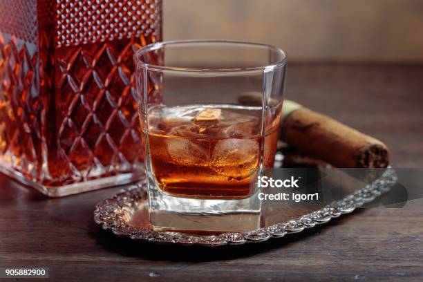 Glass Of Whiskey And Cigar On Old Wooden Table Stock Photo - Download Image Now - Alcohol - Drink, Amber, Backgrounds
