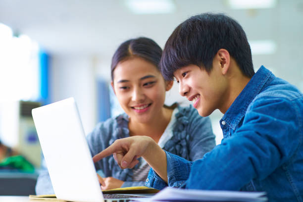 istock Two young asian college students study in the library 905883558