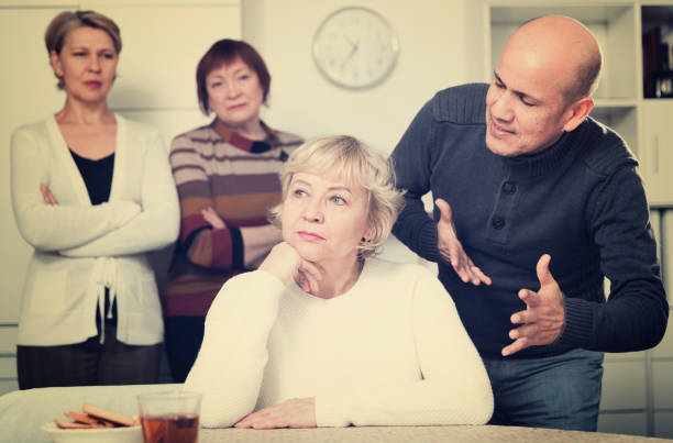 istock Mature female is sitting upset and man is apologizing 905884094