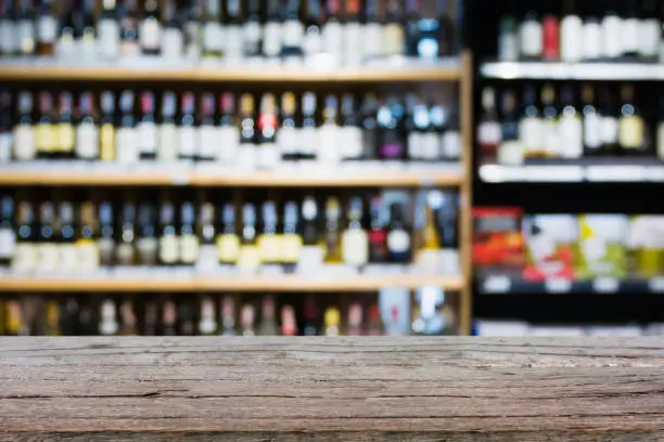 Photo of Abstract blur wine bottles on liquor alcohol shelves in supermarket background