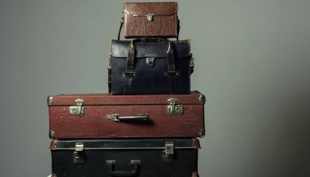 istock Background stack of old shabby suitcases form a tower 905890120