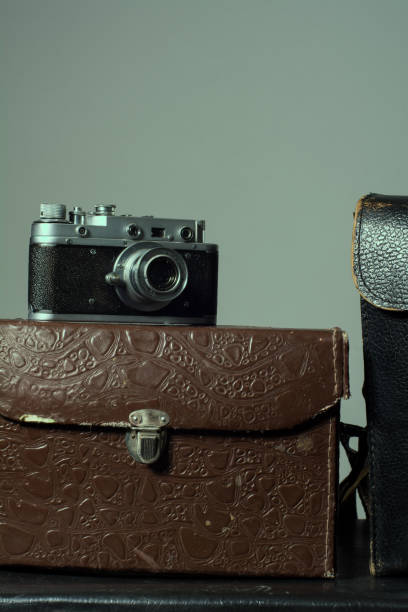 istock Close-up of a stack vintage shabby suitcases and camera 905890154