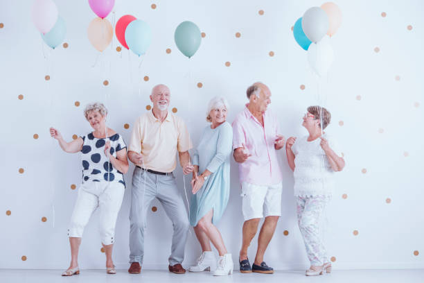 istock Pensioners dancing at party 905890418