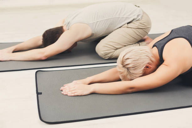 istock Couple training yoga in child's pose. 905893644