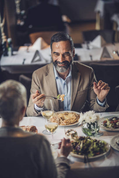 istock Happy mature couple talking during lunch time in a restaurant. 905893710