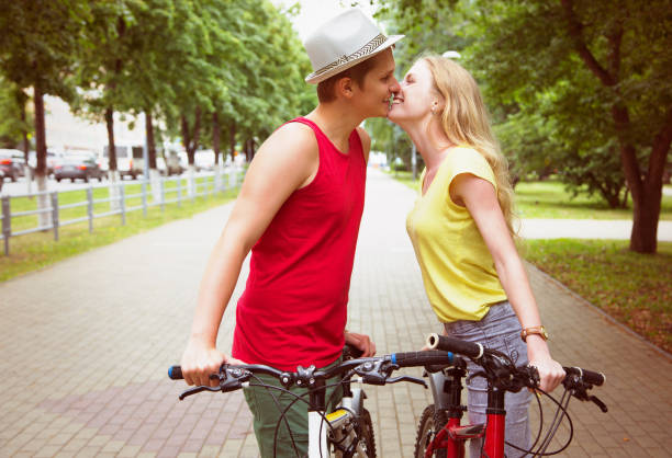 istock Happy couple kissing during a bicycle ride 905894594
