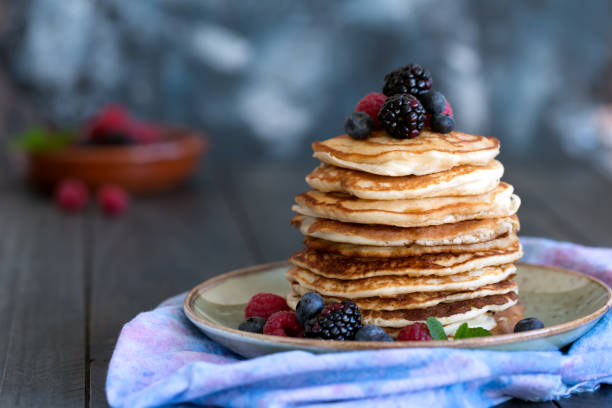 istock Pancakes with berries and honey 905897308