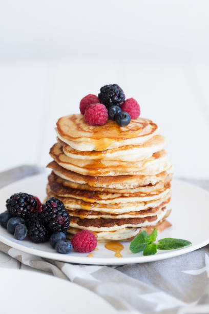 istock Pancakes with berries and honey 905897476
