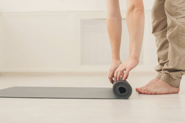 istock Rolling up fitness mat for exercise copy space 905897544