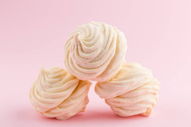 istock Homemade white zephyr or marshmallow on pink background 905898216