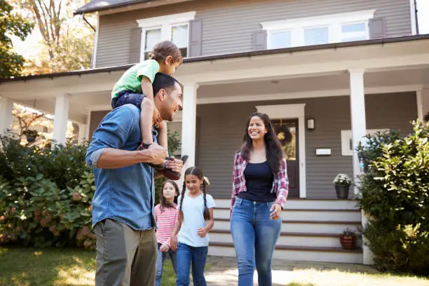 Photo of Father Gives Son Ride On Shoulders As Family Leave House