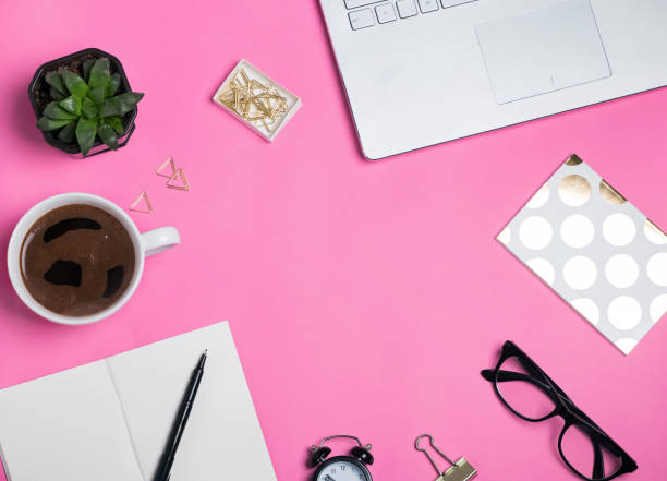 istock Coffee, glasses laptop and other objects on the bright pink background 905901536