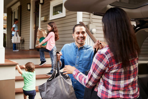 istock Family Unloading Shopping Bags From Car 905902142
