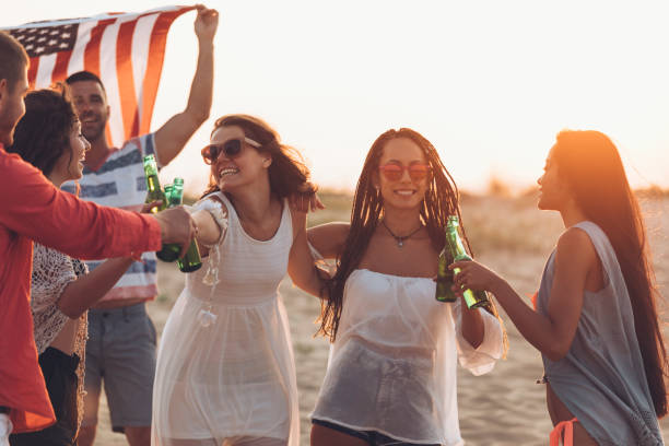 istock Hipster  friends at beach on sunset 905905056