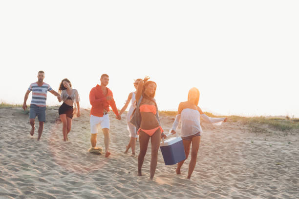 istock Hipster  friends at beach on sunset 905905058