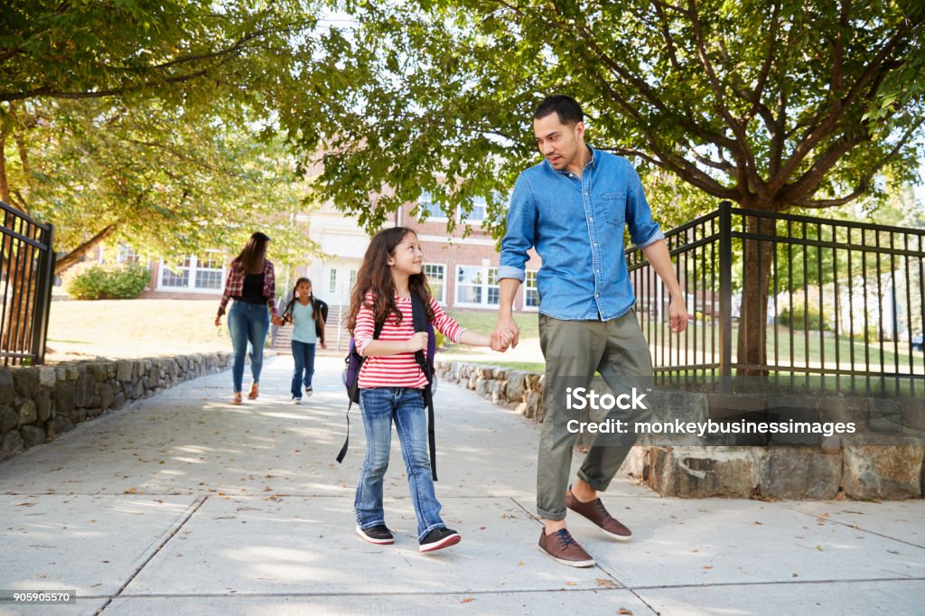 Father In Collecting Daughter At The End Of School School Building Stock Photo