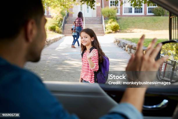 Father In Car Dropping Off Daughter In Front Of School Gates Stock Photo - Download Image Now