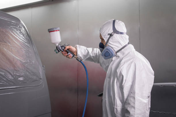 istock Painter spray gun in the hands of a painter. 905906046
