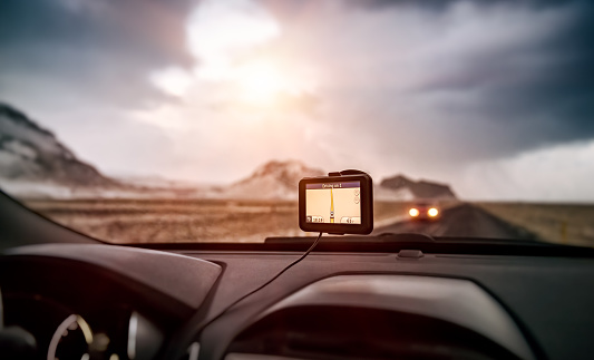 GPS navigator in the car, modern device to find right route, electronic maps all over the world, global positioning system, travel and road trips concept