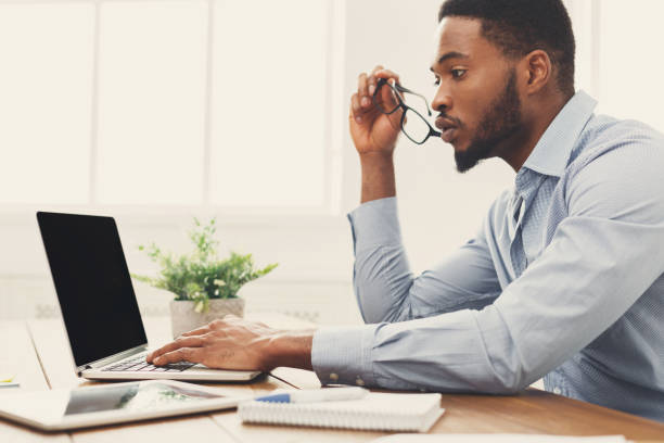 istock African-american businessman typing on laptop 905910946