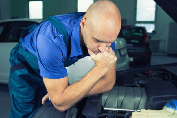 istock Young car service technician who repair the car engine motor. 905911316