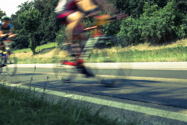 istock cyclists on street, motion blur 905914412