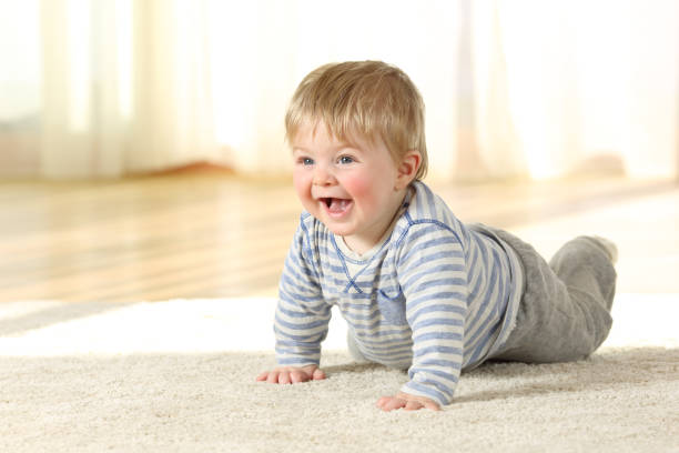 istock Happy baby crawling on a carpet at home 905918116