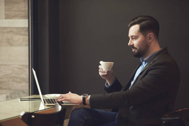 istock Businessman sitting in cafe. 905918134