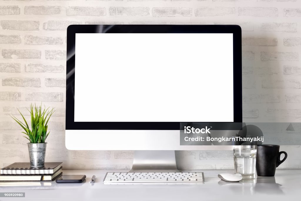 Modern clean workspace mockup with blank screen desktop computer and office supplies. Desk Stock Photo