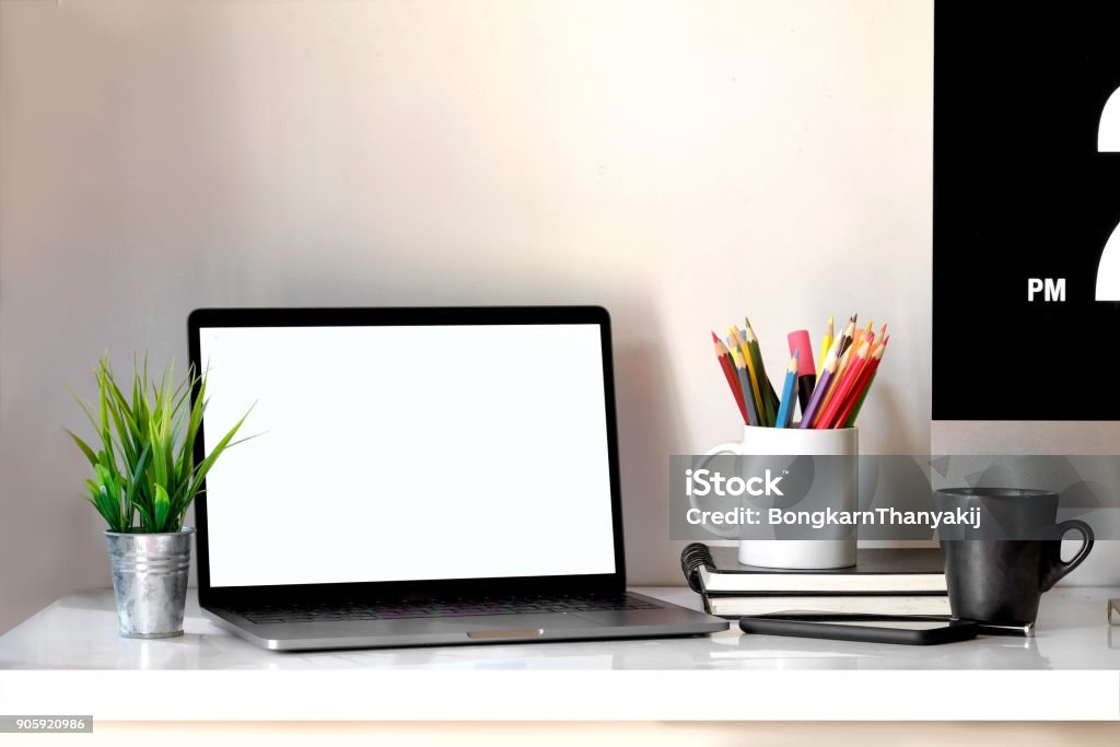 Stylish workspace with laptop, coffee mug and designer or office supplies at home or studio. Mock up. Blank Stock Photo