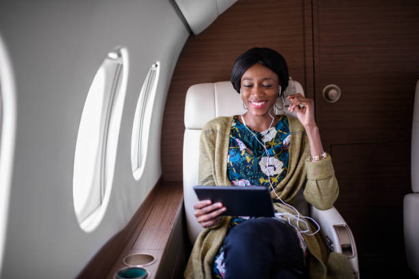 istock Woman in private jet airplane 905922316