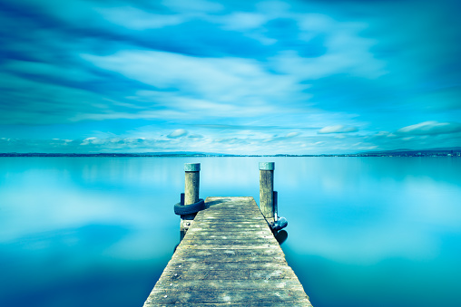 Abstract landscape. Wooden pier on Lake Zug in Switzerland. Long exposure.