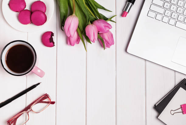 istock Computer, glasses, coffee and accessories in pink color on white 905923290