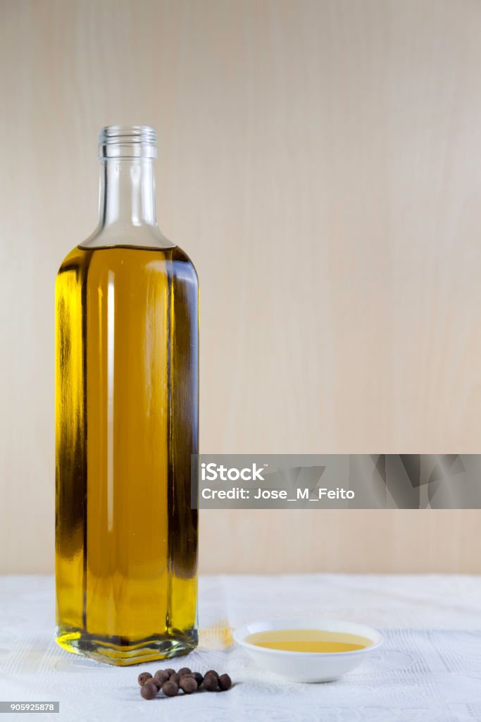 bottle olive oil bottle olive oil with  test plate and Peppercorns on brown and white background Agriculture Stock Photo