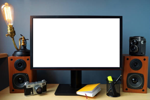 istock Monitor on an office desk with vintage lamp and  camera. 905926042