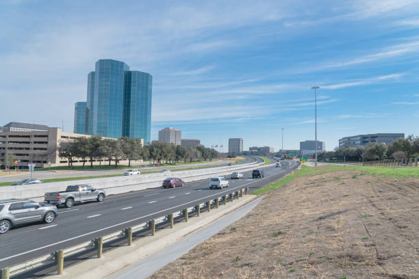 Irving, Texas skyline view from John Carpenter Freeway under winter cloud blue sky. Cityscape and transportation background.
