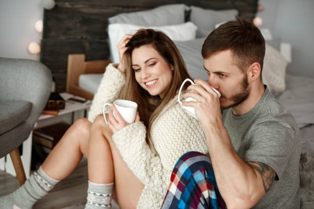 istock Affectionate couple drinking morning coffee at bedroom 905927442