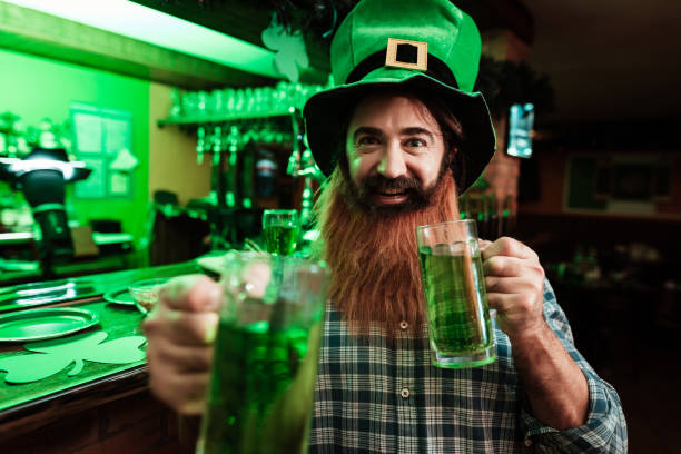 istock A man in a leprechaun hat and with a beard drinks beer in a bar. 905927662
