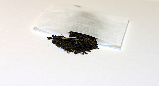 Green Tea Spilling Out of  Bag - Isolated stock photo