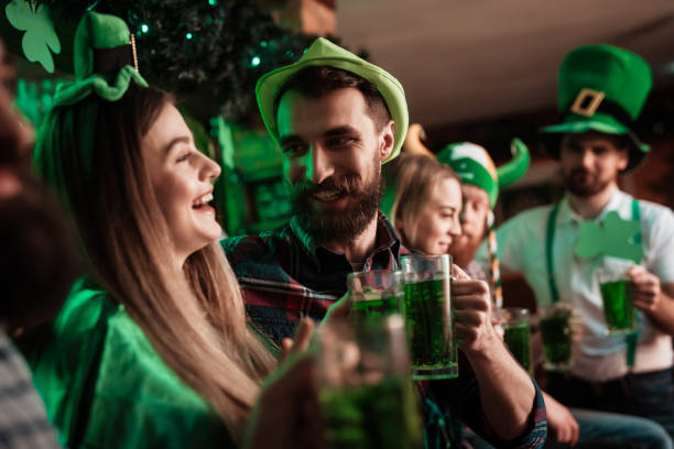 The company of young people celebrate St. Patrick's Day. stock photo
