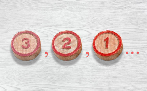 Three Wooden Pieces Depicting the Countdown from Three to One stock photo