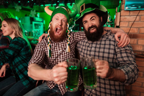 istock Two men in carnival caps celebrate St. Patrick's Day. 905933214