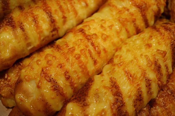 istock Closed up Cheese Bread Sticks Lined up on the Tray, for Texture or Background 905933252