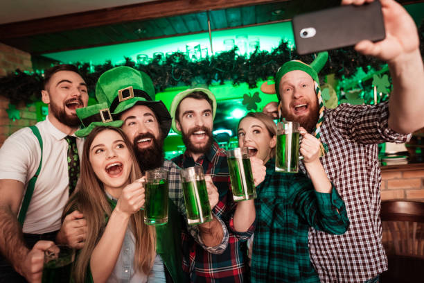 istock Group of young people doing selfie on a mobile phone in a bar. 905933462