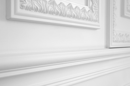 Close-up of a wall with a polyurethane antique decorative moulding (baroque style interior architecture element).