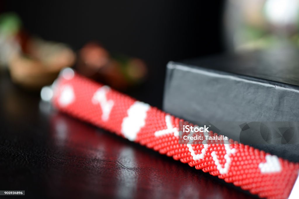 Red beaded I Love You bracelet on a dark background close up Art Stock Photo