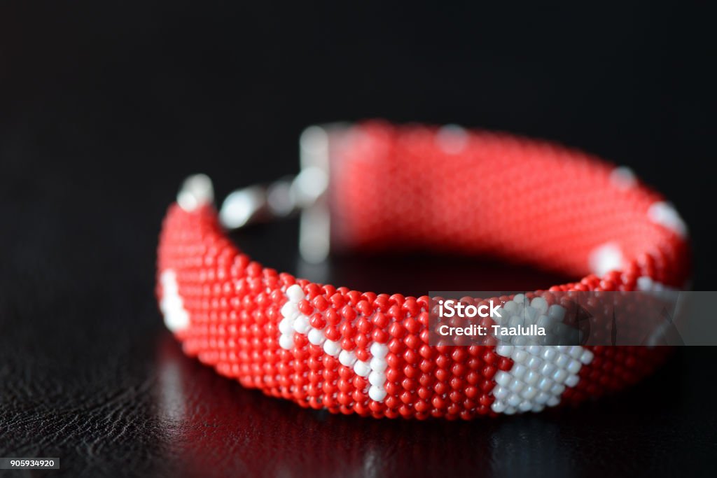 Valentine's Day red beaded bracelet on a dark background close up Art Stock Photo