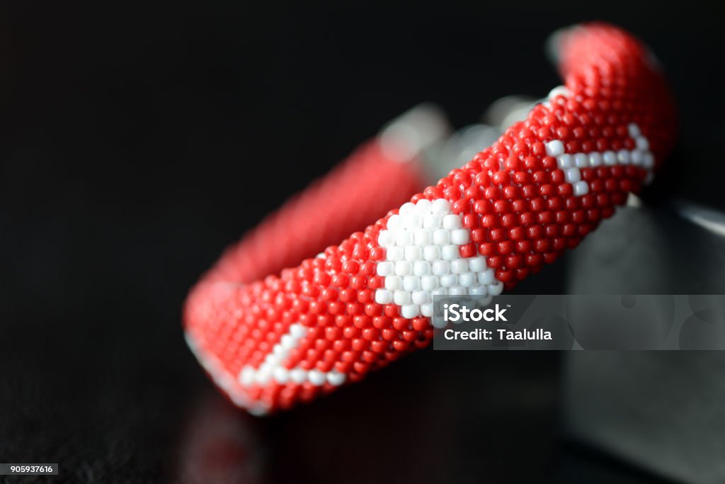 Valentine's Day red beaded bracelet on a dark background close up Art Stock Photo